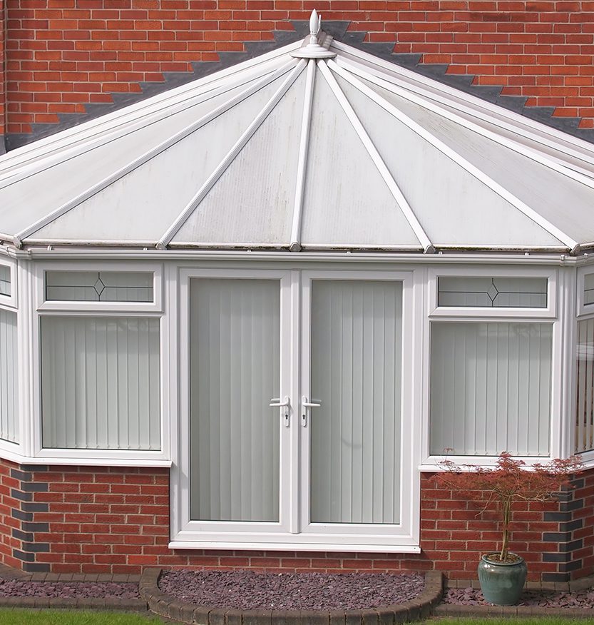 white brick and upvc conservatory at rear of house