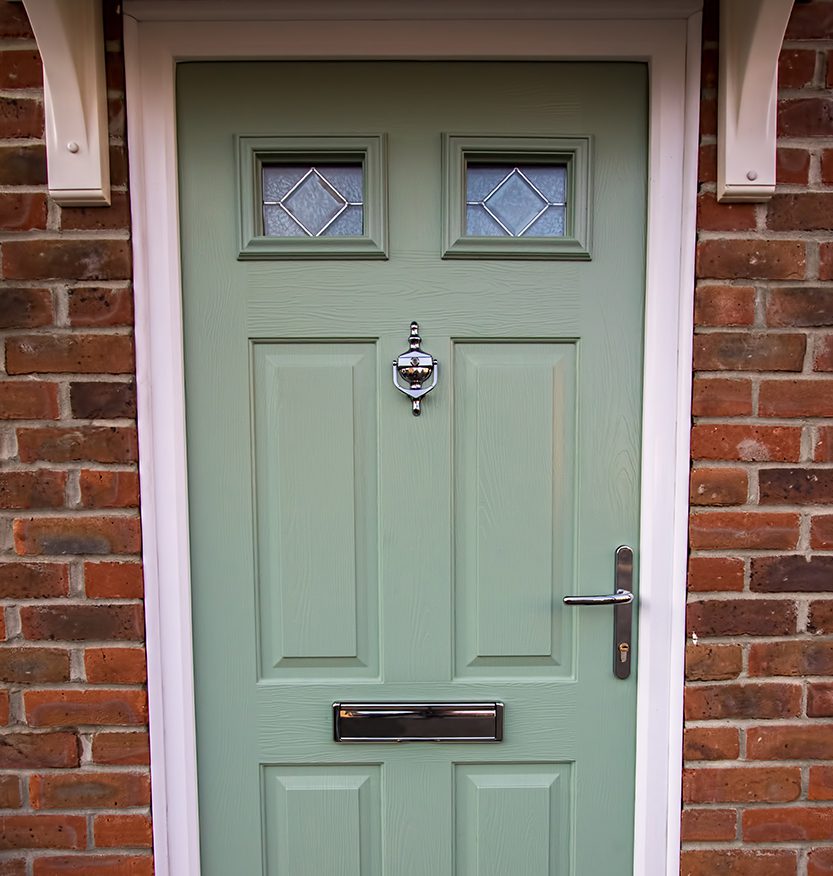 Green door. Modern house composite upvc front door with chrome hardware. Timber look classic design.